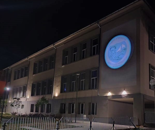 Проектирано лого осветява фасадата на царевското училище вечер